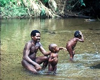  Batek man bathing two of his kids in a stream, a tributary of the Lebir River in Malaysia. Photo courtesy of Kirk and Karen Endicott.