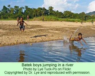 Batek boys jumping in a river