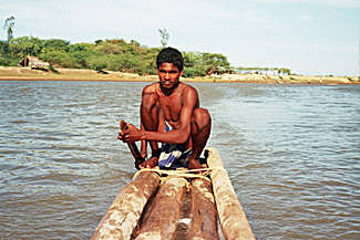 A Yanadi fisherman paddling a log boat
