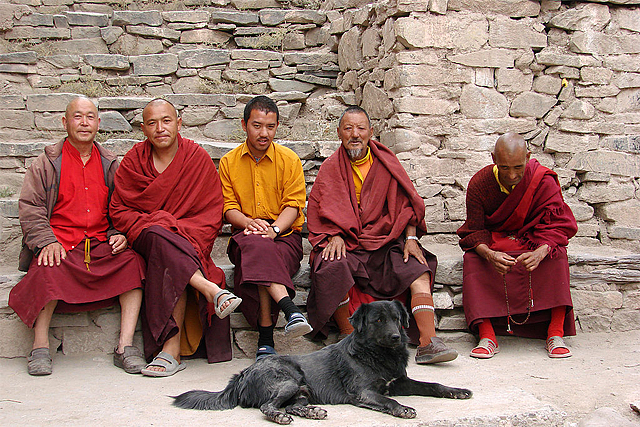 Some monks at the famed Hemis Monastery with a dog 