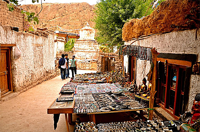 Vendors' stalls displaying jewelry and trinkets along an alley outside the Alchi Monastery 