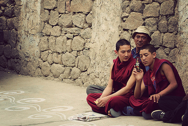 Monks at the Thiksey Monastery with a cellphone 