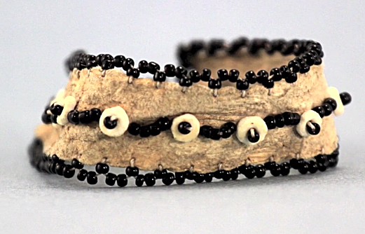 A headband made out of leather plus ostrich eggshell and glass beads preserves the traditional wandering pattern beloved by Ju/’hoansi jewelry makers