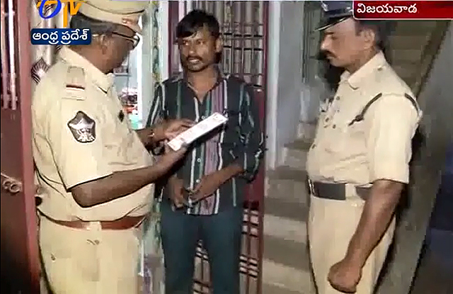 Andhra Pradesh police speak with a man in a jail cell 