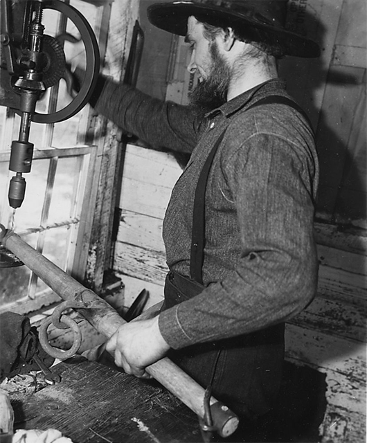 An image from 1941 of an Amish man working in his shop