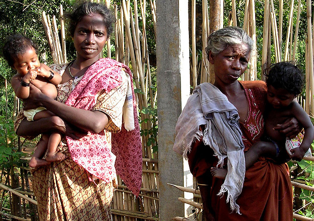 Tribal family, old and young women plus children, probably Kadar, photographed in a Kadar area near Kochi, Kerala 