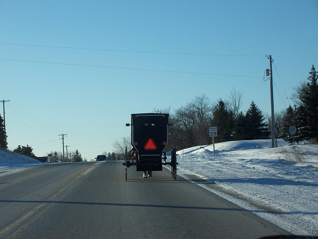 Amish buggy driven along the road on a bitterly cold January morning near St. Anna, Wisconsin 