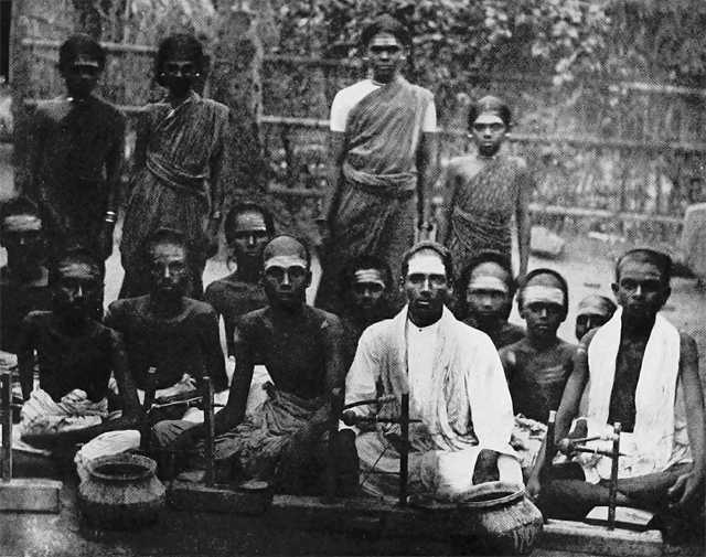 A group of Malapandarams engaged in polishing precious stones 