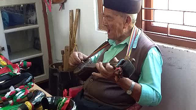 A Lepcha man, Sonam Tshering Lepcha, playing a string instrument in the Lepcha Museum, Kalimpong, India, that he designed himself 