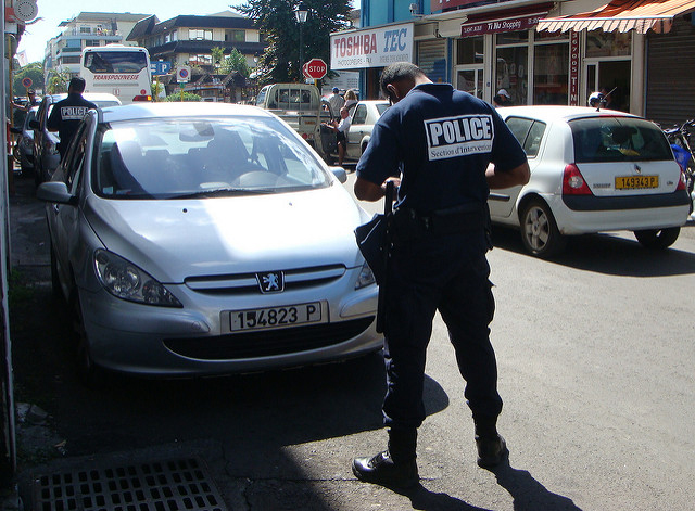 A police officer in Papeete writing out a ticket 