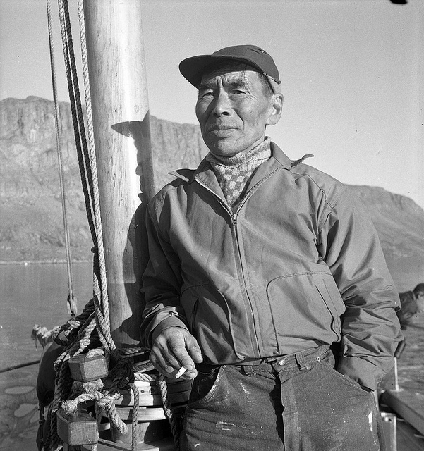 Eetuk, an Inuit man, standing in a boat in Frobisher Bay, now Iqaluit, in 1960 