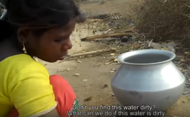 Birhor woman being interviewed about drinking dirty water at her village in Jharkhand 