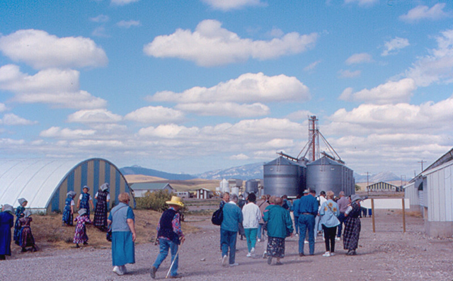 A group taking a tour of the Milford Colony, Montana, work buildings 
