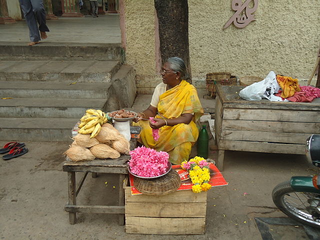 A seller of produce at a market in the Palni Hills