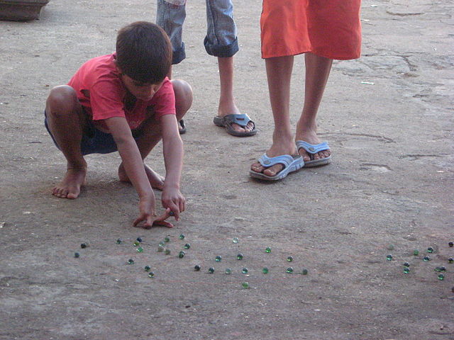 Indian kids playing with marbles in Mumbai 